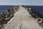 Daugavgrīvas mols ir būvēts 1880. gadā un tas stiepjas jūrā ZR virzienā tikpat tālu kā upes labajā krastā esošais Mangaļsalas dambis 1